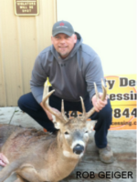 Man holding killed buck