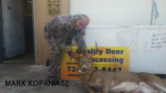 Man holding killed buck