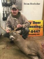Man holding killed buck