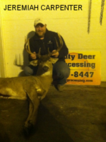 Man holding killed buck