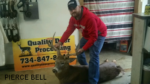 Man holding killed buck