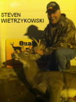Man holding killed buck