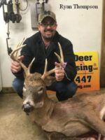 Man holding killed buck