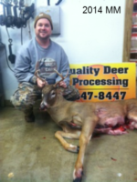 Man holding killed buck