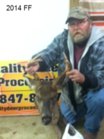 Man holding killed buck
