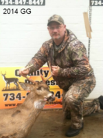 Man holding killed buck