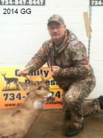 Man holding killed buck