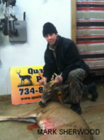 Man holding killed buck