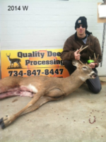 Man holding killed buck
