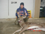 Man holding killed buck