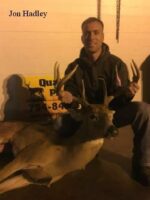 Man holding killed buck