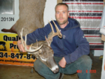Man holding killed buck