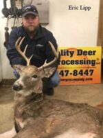 Man holding killed buck