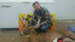 Man holding killed buck