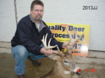 Man holding killed buck