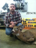 Man holding killed buck