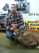 Man holding killed buck