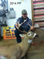 Man holding killed buck