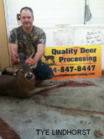 Man holding killed buck