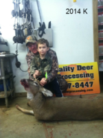 Man holding killed buck