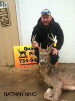 Man holding killed buck