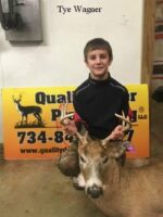 boy holding killed buck