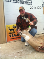 Man holding killed buck