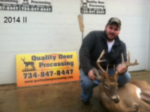 Man holding killed buck
