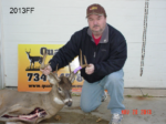 Man holding killed buck