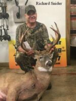 Man holding killed buck