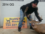 Man holding killed buck