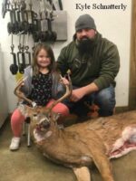 Man and girl holding killed buck