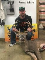 Man holding killed buck