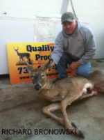 Man holding killed buck