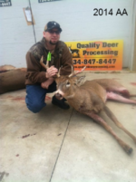 Man holding killed buck