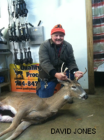 Man holding killed buck