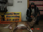 Man holding killed buck