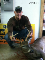 Man holding killed buck