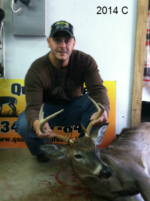 Man holding killed buck