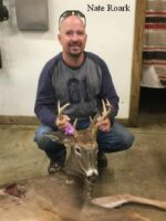 Man holding killed buck