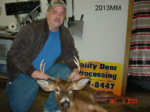 Man holding killed buck