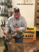 Man holding killed buck