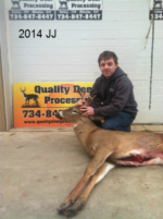 Man holding killed buck
