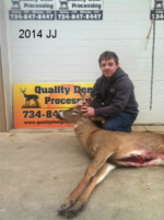 Man holding killed buck