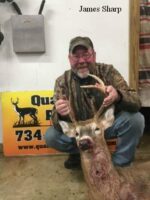 Man holding killed buck