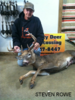 Man holding killed buck