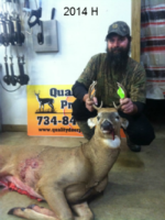 Man holding killed buck