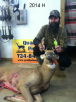 Man holding killed buck