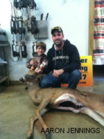 Man holding killed buck
