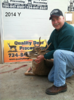 Man holding killed buck